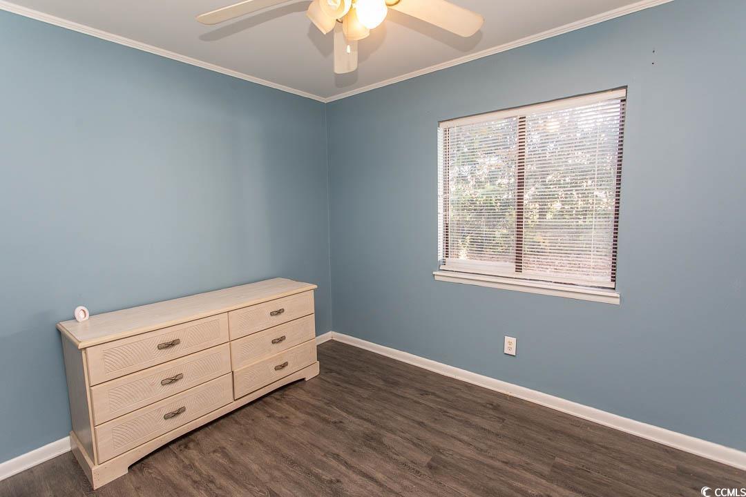 950 Forestbrook Road, Unit C3 Myrtle Beach, SC 29579 - Photo 6 of 19 Bedroom with ornamental molding, dark wood finished floors, and a ceiling fan