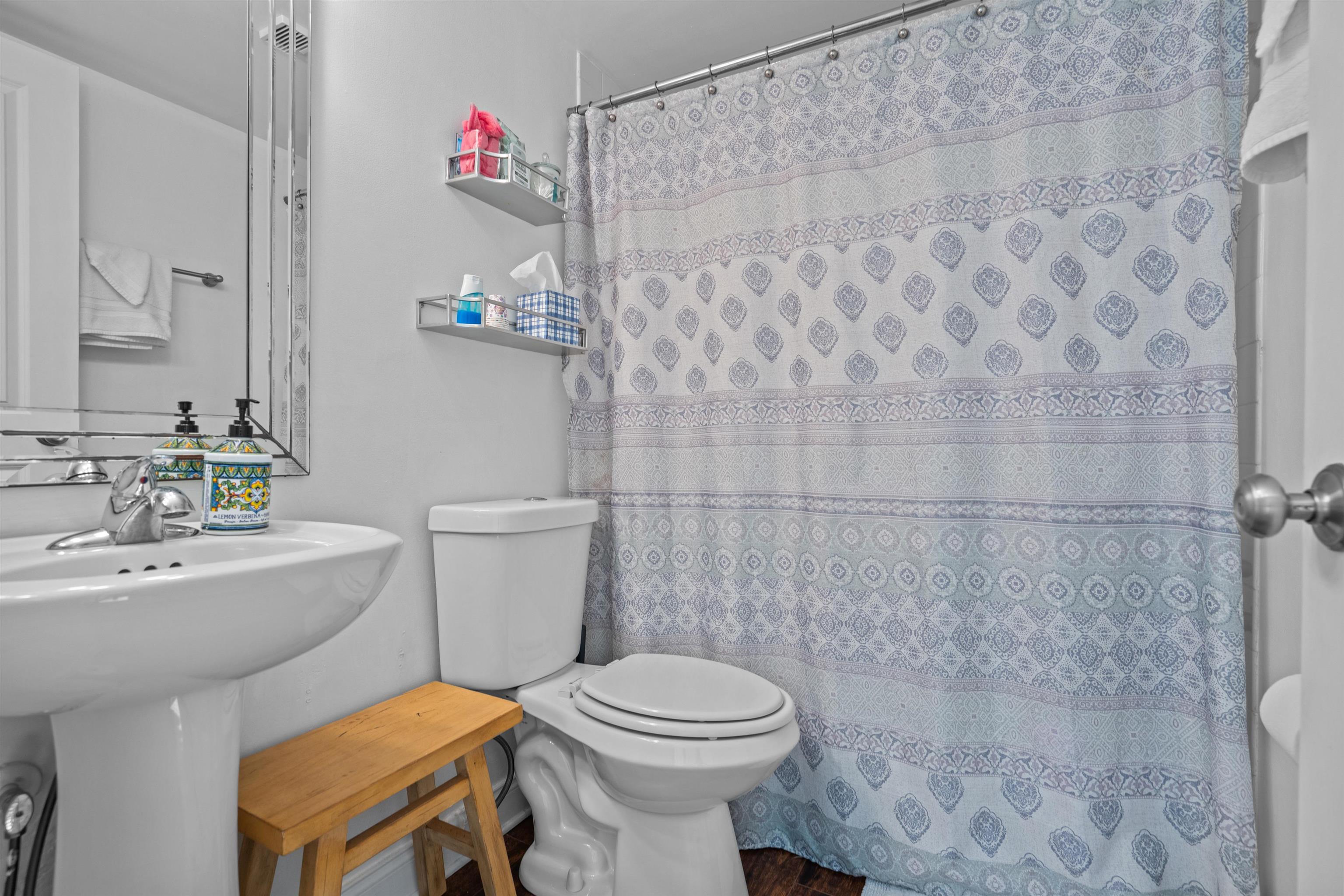 11 Tarragona Court St. Augustine, FL 32086 - Photo 4 of 33 a bathroom with a sink a toilet and shower curtain