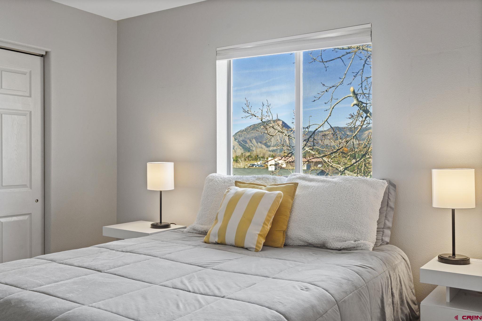 1100 Goeglein Gulch Road, Unit 233 Durango, CO 81301 - Photo 13 of 37 a bedroom with a bed and a lamp