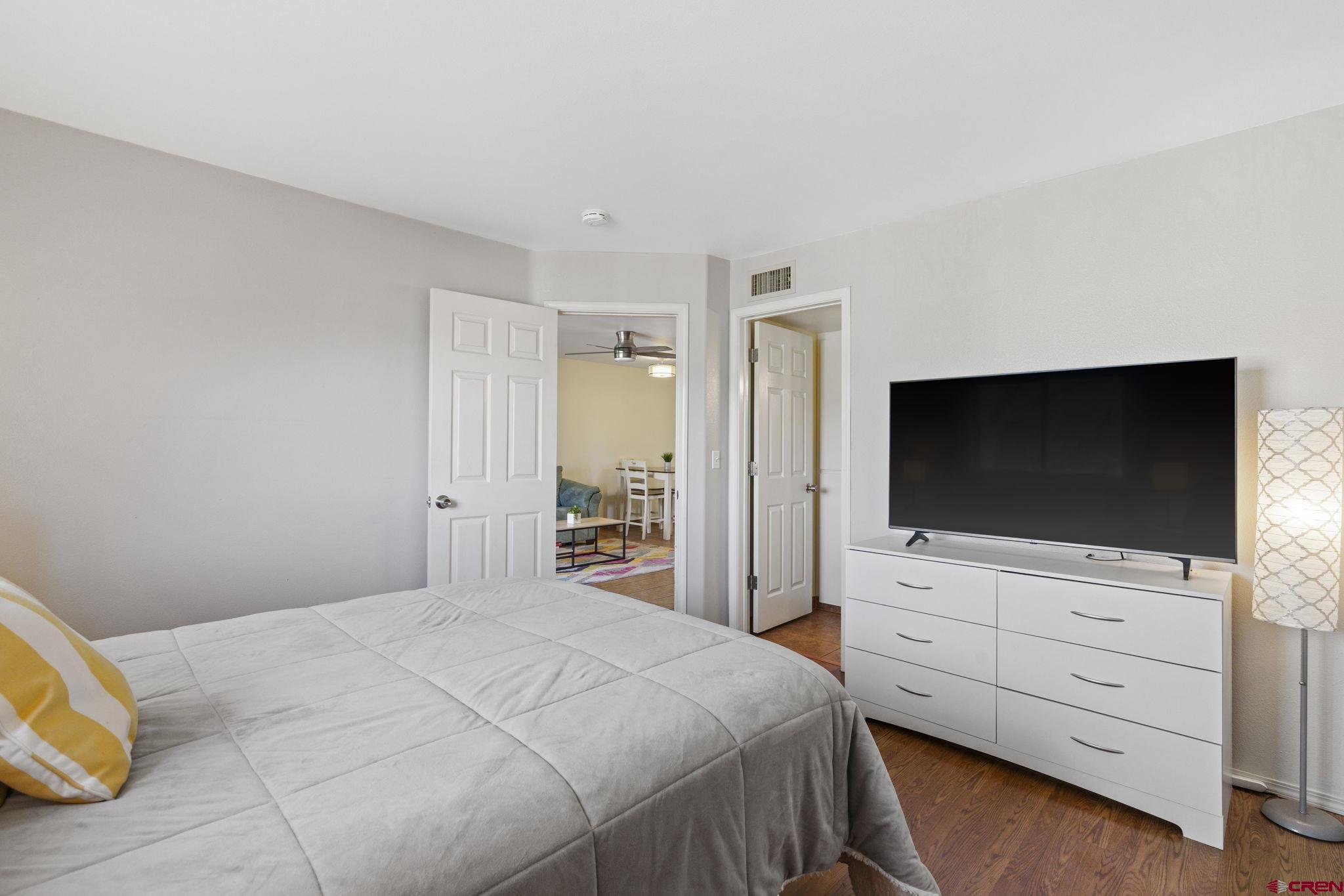 1100 Goeglein Gulch Road, Unit 233 Durango, CO 81301 - Photo 14 of 37 a bedroom with a bed and a flat screen tv