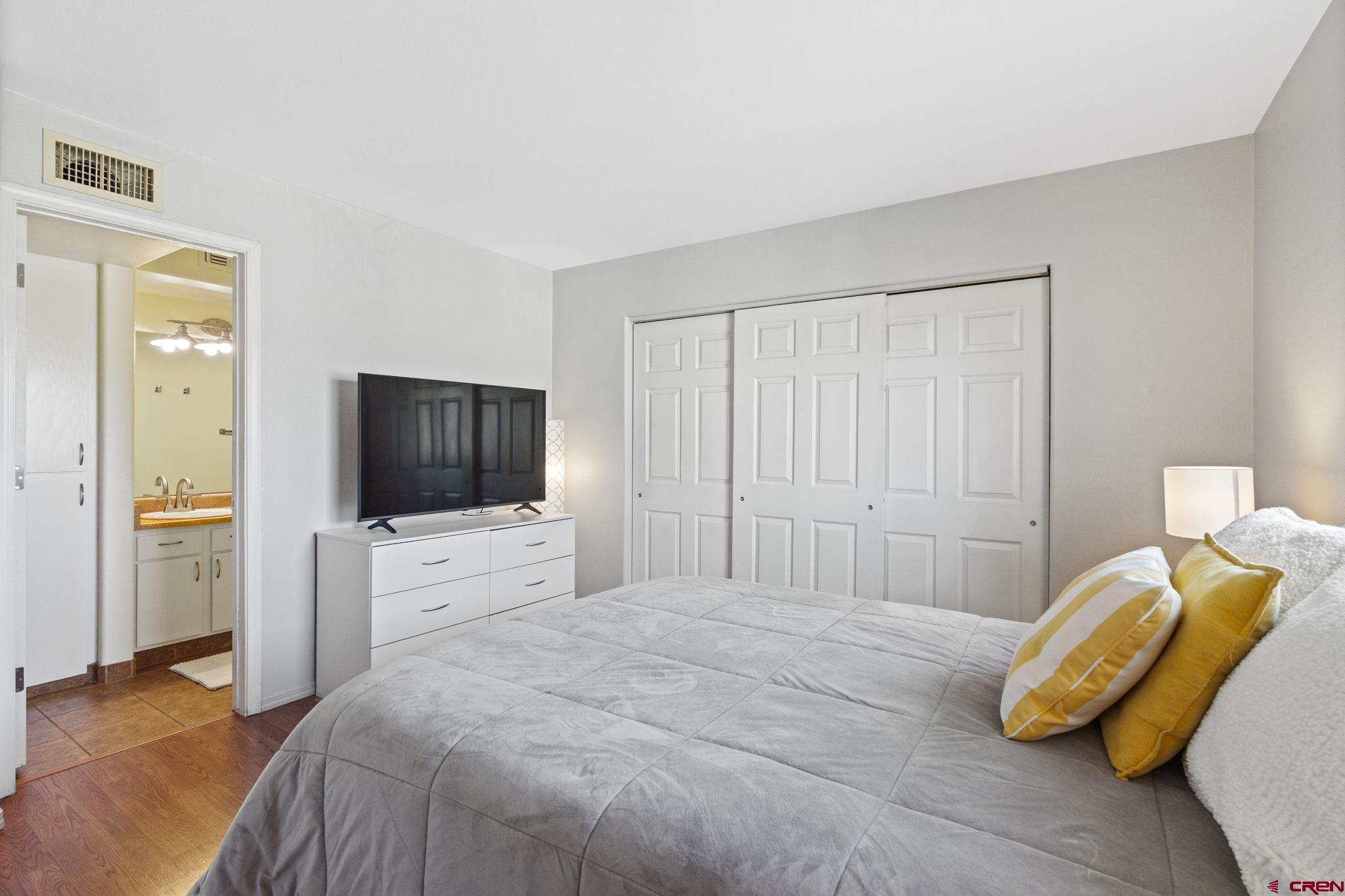 1100 Goeglein Gulch Road, Unit 233 Durango, CO 81301 - Photo 15 of 37 a bedroom with a bed and a flat screen tv