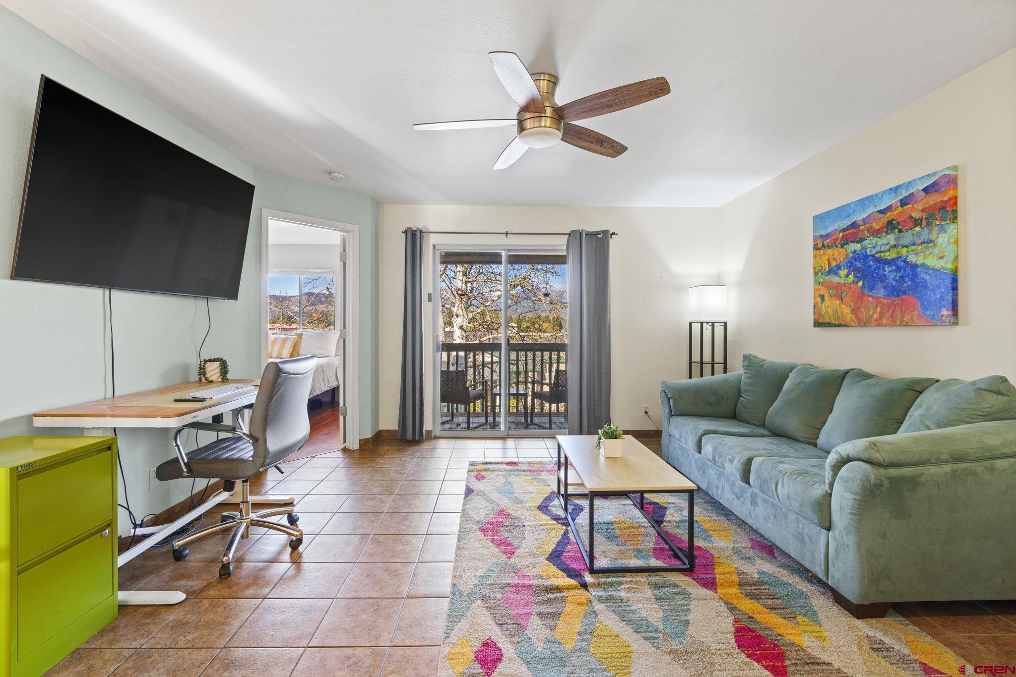 1100 Goeglein Gulch Road, Unit 233 Durango, CO 81301 - Photo 2 of 37 a living room with furniture and a flat screen tv