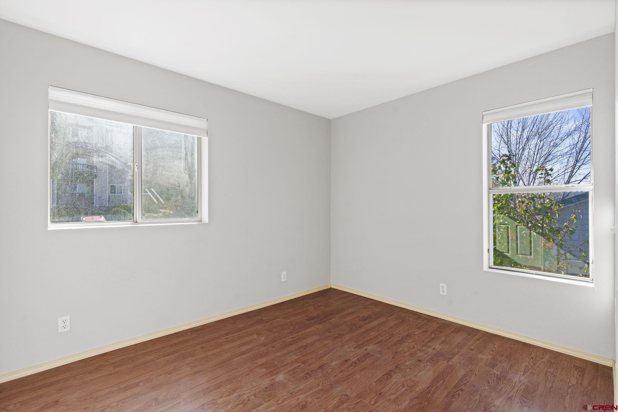 1100 Goeglein Gulch Road, Unit 233 Durango, CO 81301 - Photo 21 of 37 a view of an empty room with a window and wooden floor