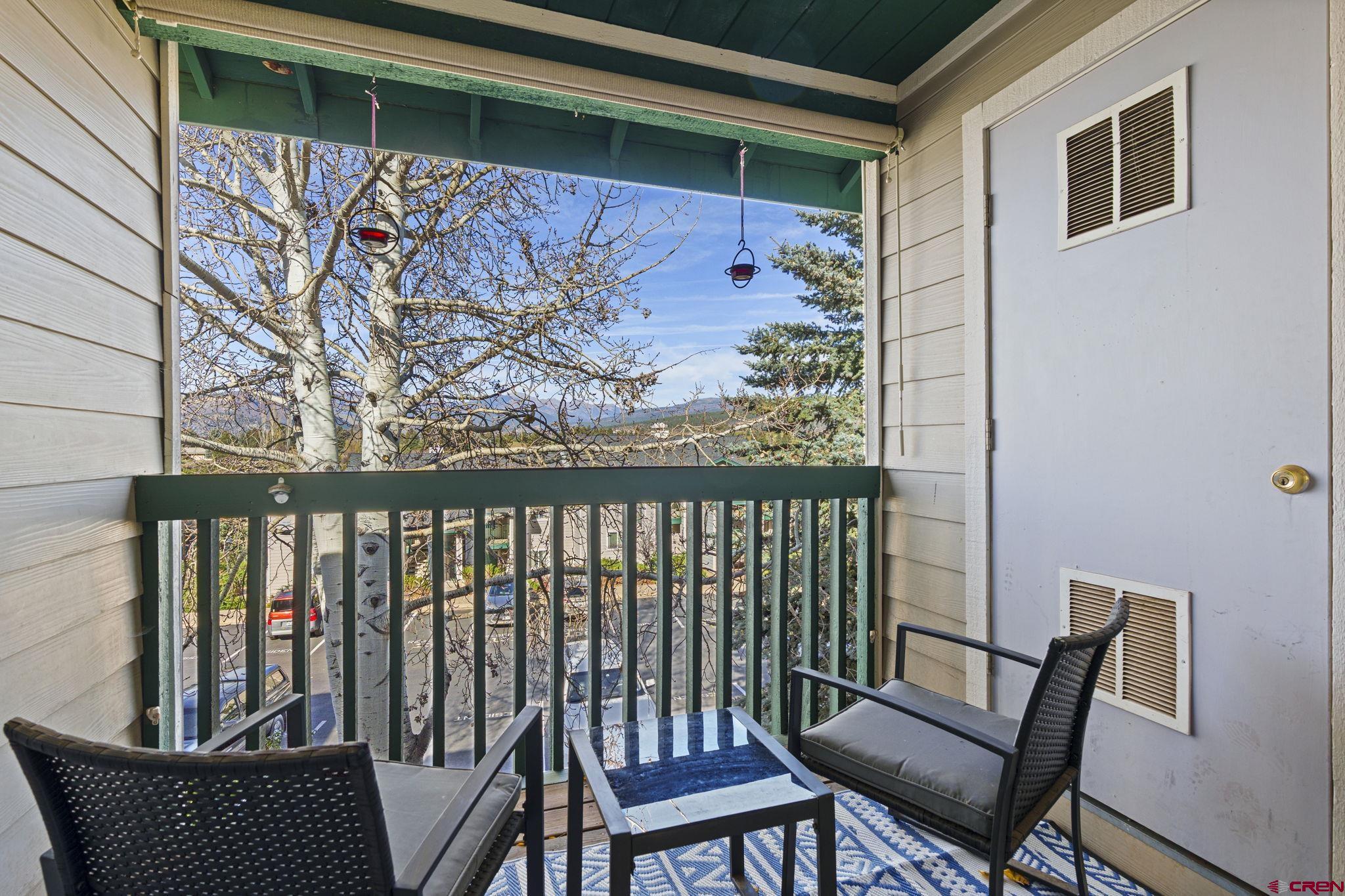 1100 Goeglein Gulch Road, Unit 233 Durango, CO 81301 - Photo 22 of 37 a view of a chair and table in the balcony