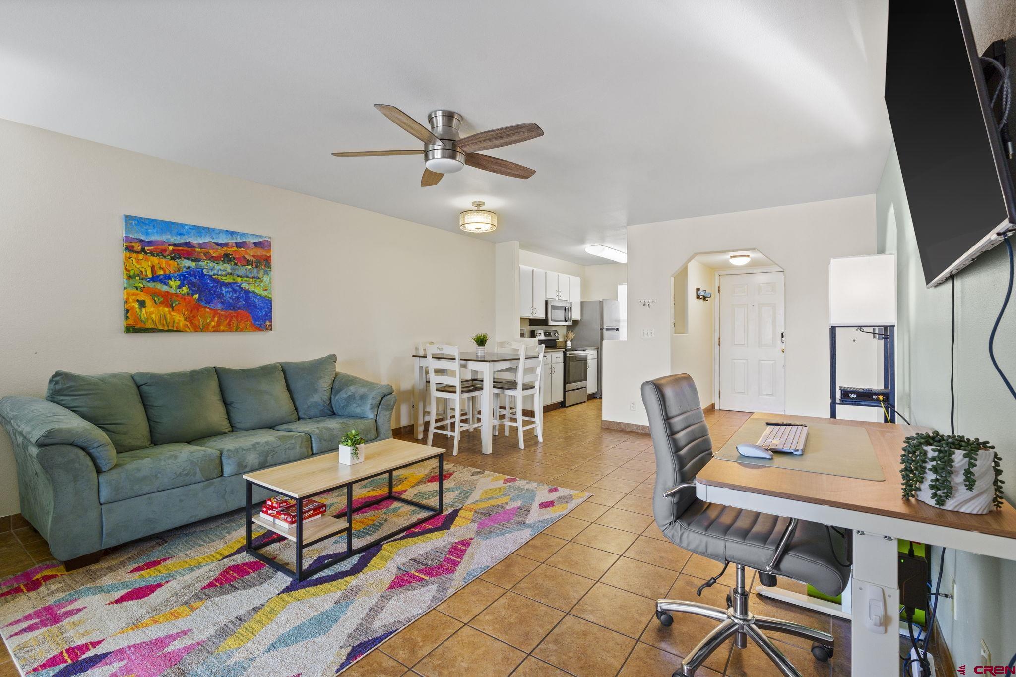 1100 Goeglein Gulch Road, Unit 233 Durango, CO 81301 - Photo 3 of 37 a living room with furniture and a flat screen tv