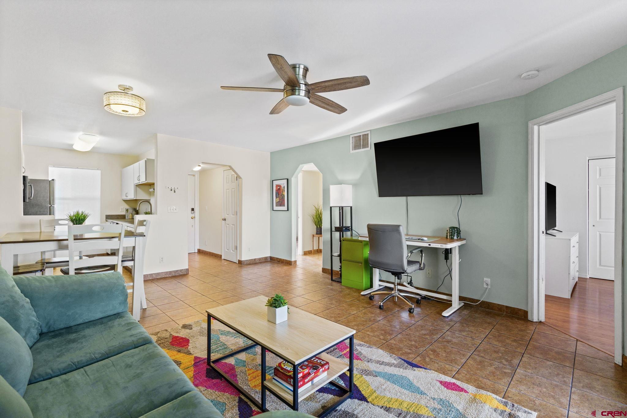 1100 Goeglein Gulch Road, Unit 233 Durango, CO 81301 - Photo 4 of 37 a living room with furniture and a flat screen tv