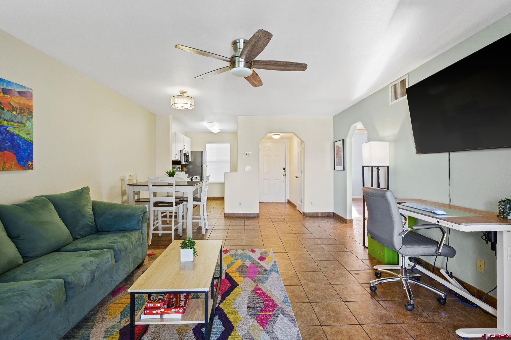 1100 Goeglein Gulch Road, Unit 233 Durango, CO 81301 - Photo 5 of 37 a living room with furniture and a flat screen tv