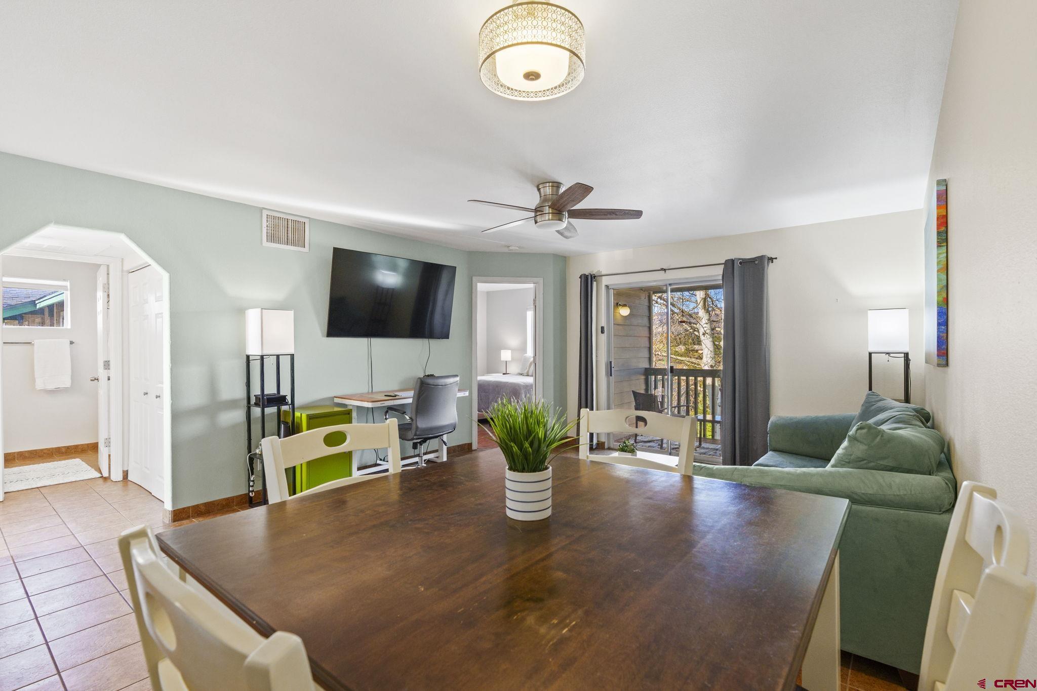 1100 Goeglein Gulch Road, Unit 233 Durango, CO 81301 - Photo 6 of 37 a living room with furniture and a flat screen tv