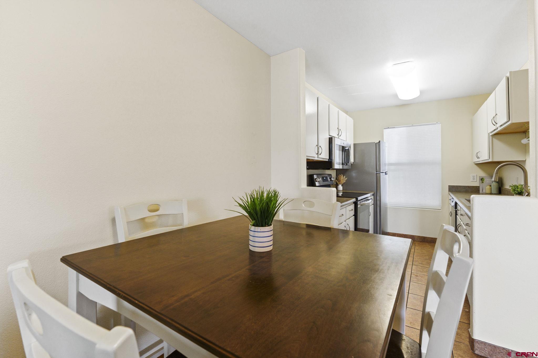 1100 Goeglein Gulch Road, Unit 233 Durango, CO 81301 - Photo 7 of 37 a kitchen with a table and chairs