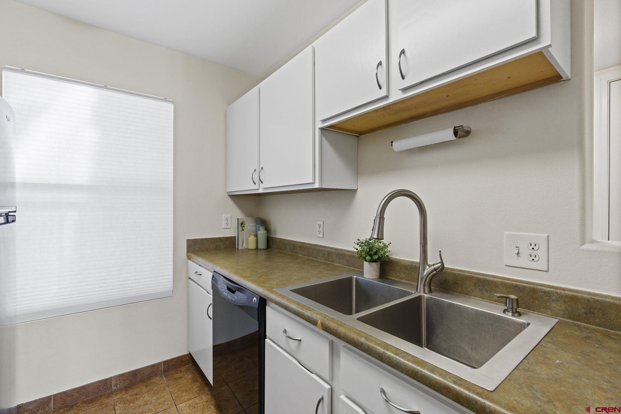 1100 Goeglein Gulch Road, Unit 233 Durango, CO 81301 - Photo 9 of 37 a kitchen with a sink and cabinets