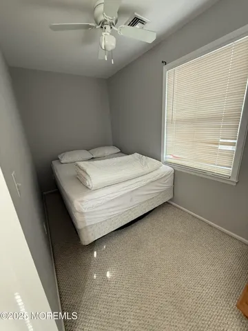 a bed sitting in a room next to a window