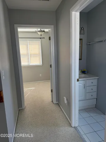 a view of cabinets and window in an empty room