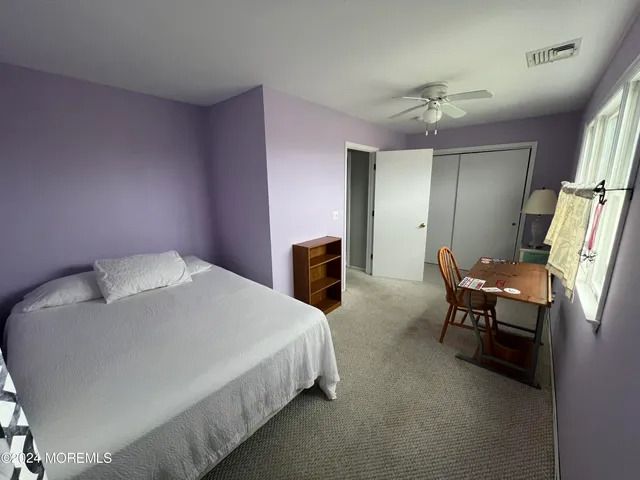 a bedroom with a bed furniture and a chandelier