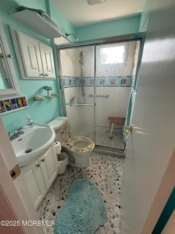 a bathroom with a sink toilet and shower