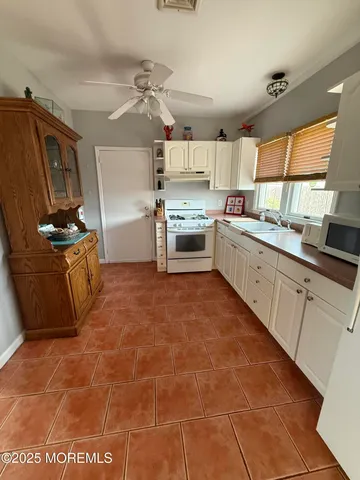 a kitchen with a sink cabinets and window