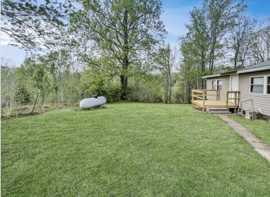 237 Higgs Road Big Rock, TN 37023 - Photo 19 of 19 a view of a backyard with table and chairs and wooden fence