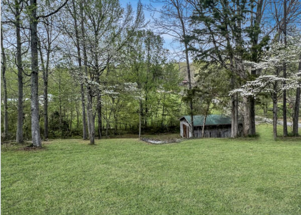 237 Higgs Road Big Rock, TN 37023 - Photo 2 of 19 a backyard of a house with lots of green space and fountain
