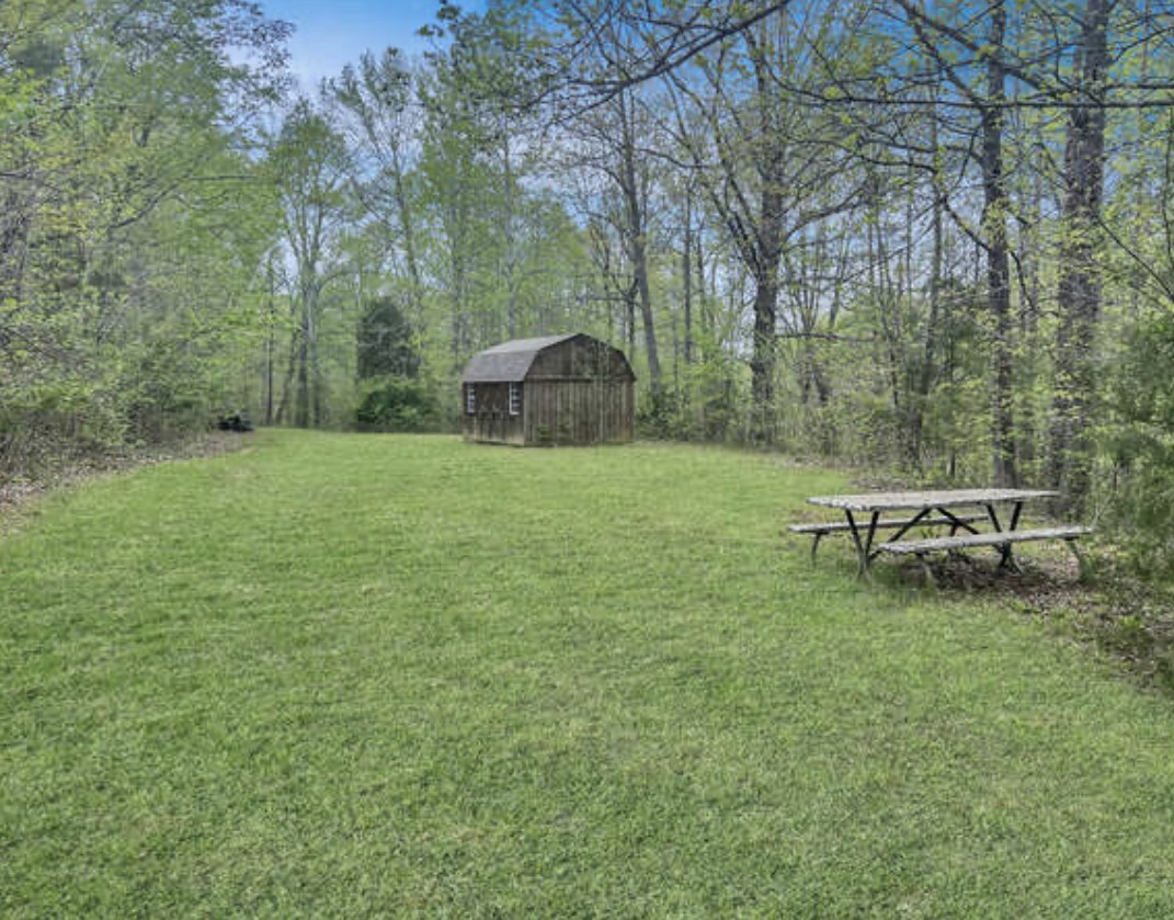 237 Higgs Road Big Rock, TN 37023 - Photo 3 of 19 a backyard of a house with table and chairs