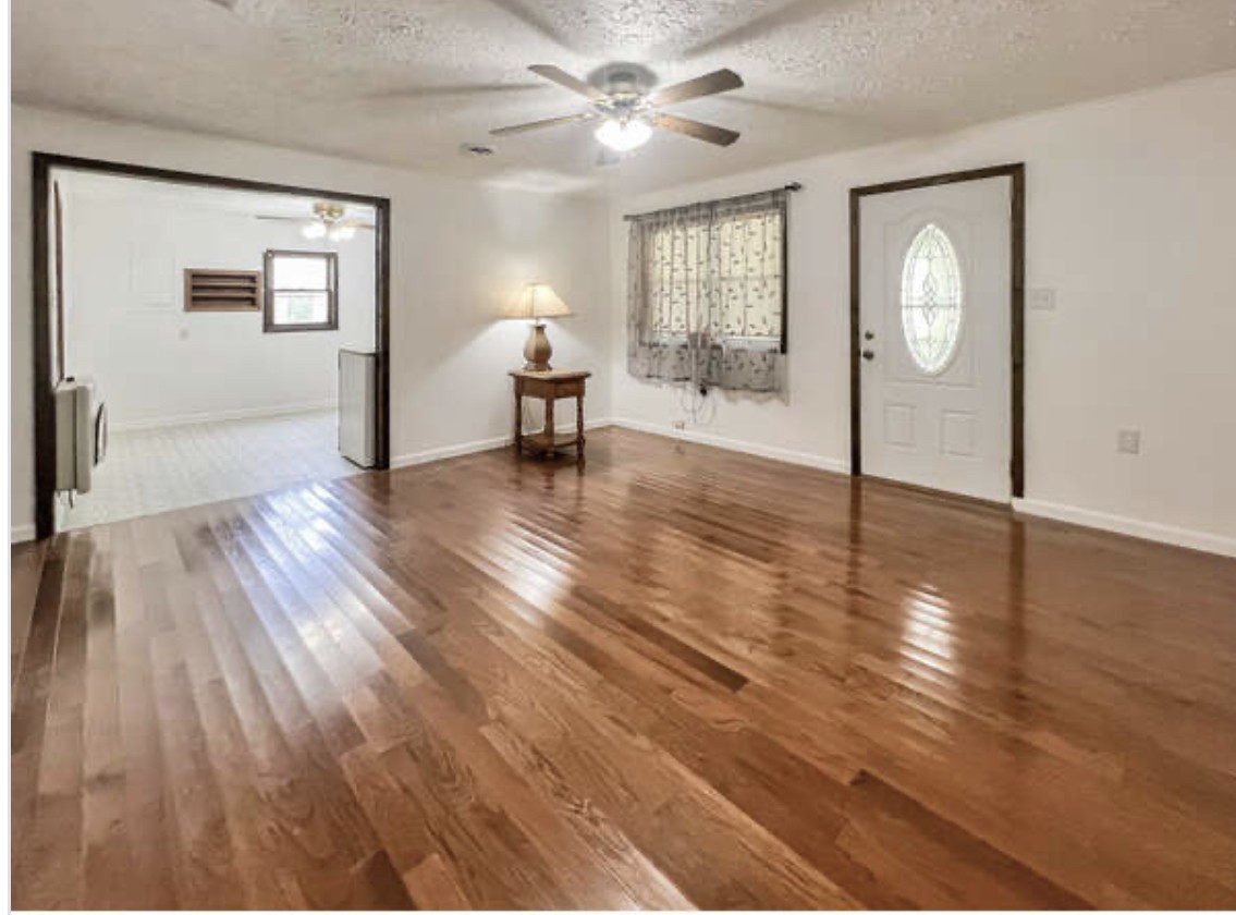 237 Higgs Road Big Rock, TN 37023 - Photo 4 of 19 a view of an empty room and window with wooden floor