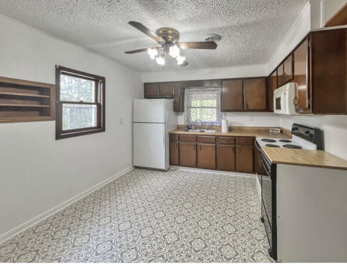 237 Higgs Road Big Rock, TN 37023 - Photo 6 of 19 a kitchen with a sink a refrigerator and cabinets