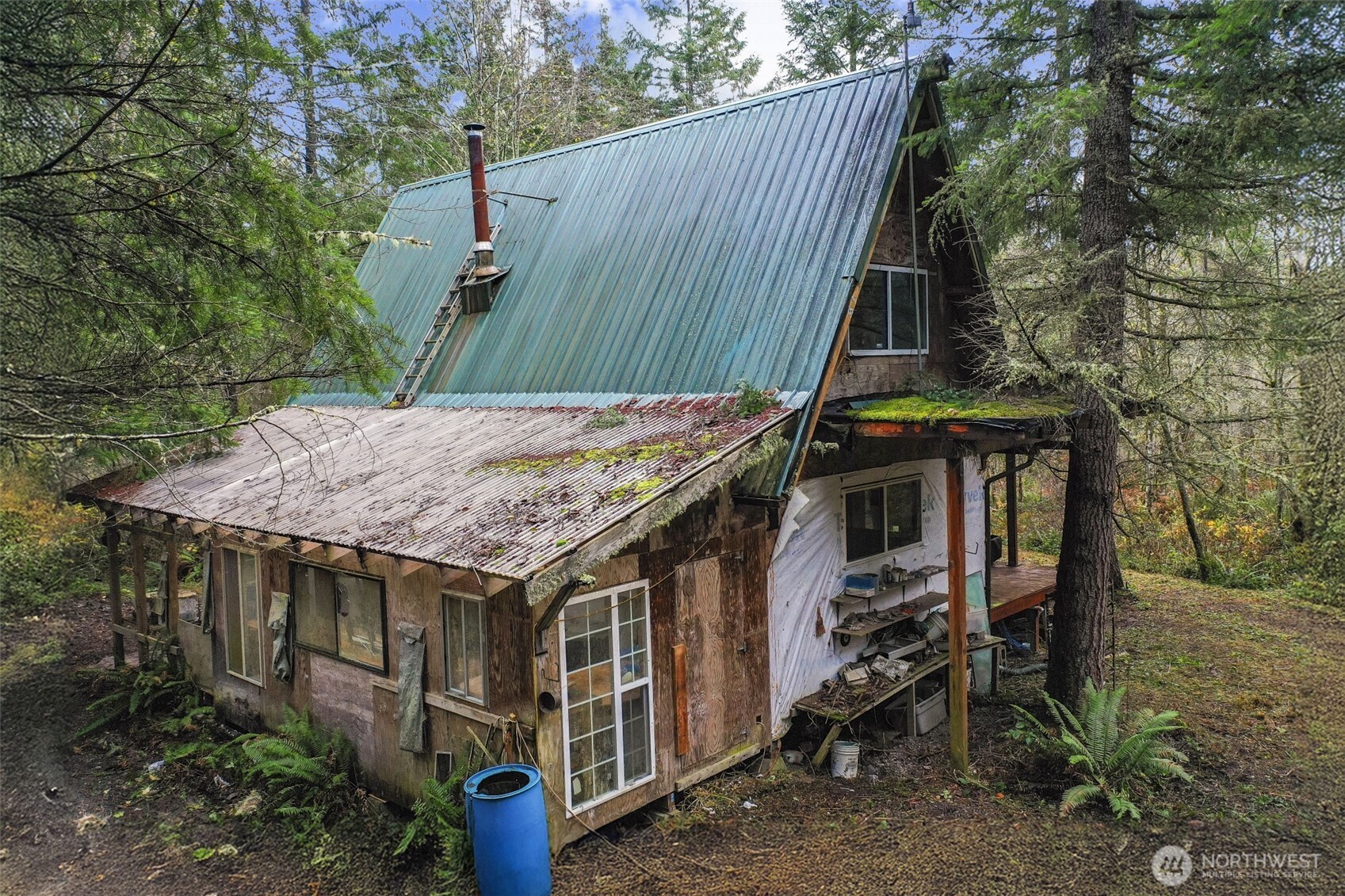 15411 Alder Mashel Connection Road East Eatonville, WA 98328 - Photo 13 of 18 a view of a house with a wooden deck and furniture