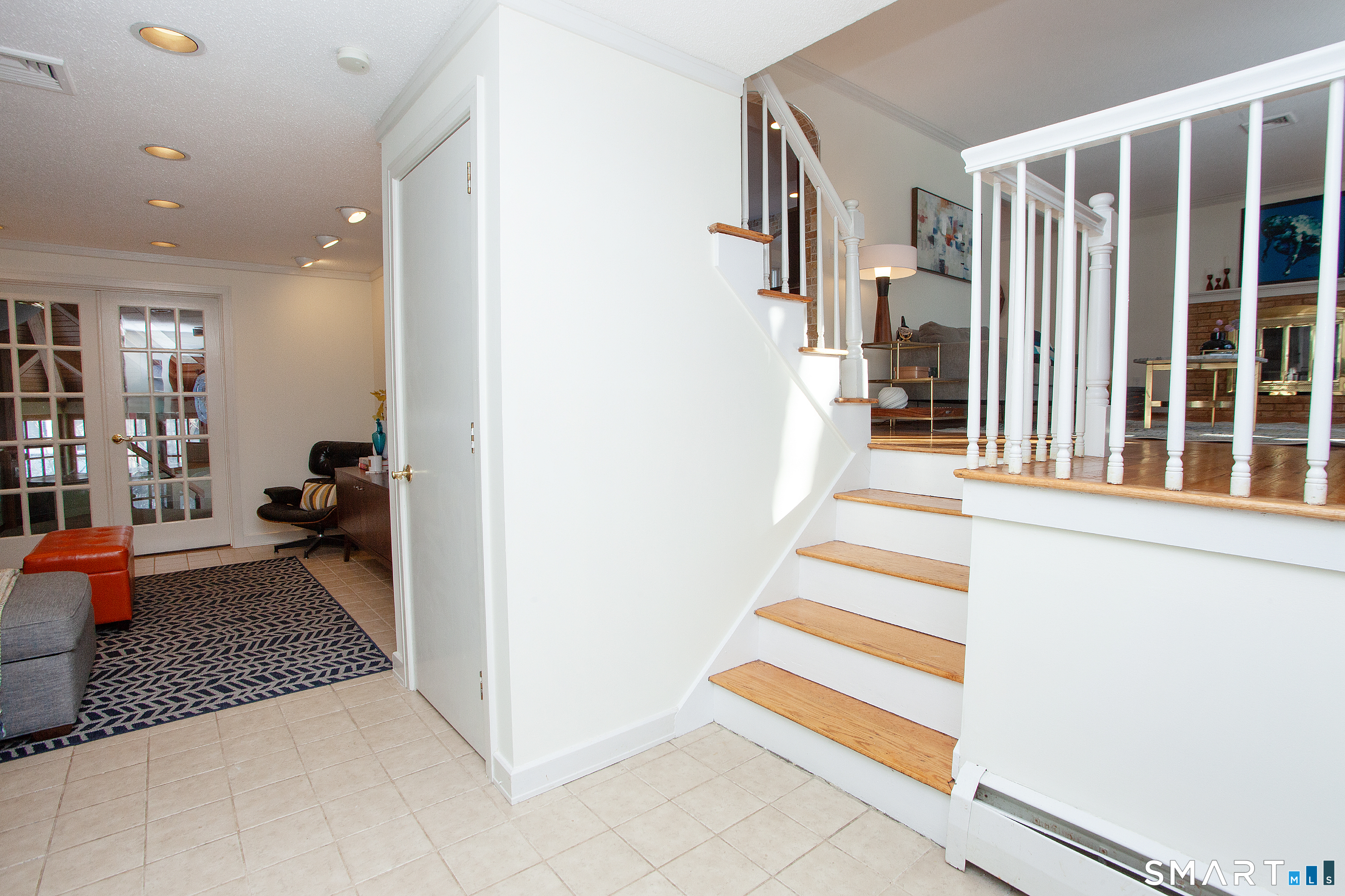 60 Ridgebrook Drive West Hartford, CT 06107 - Photo 3 of 40 Entry with family room straight ahead and living room up the stairs