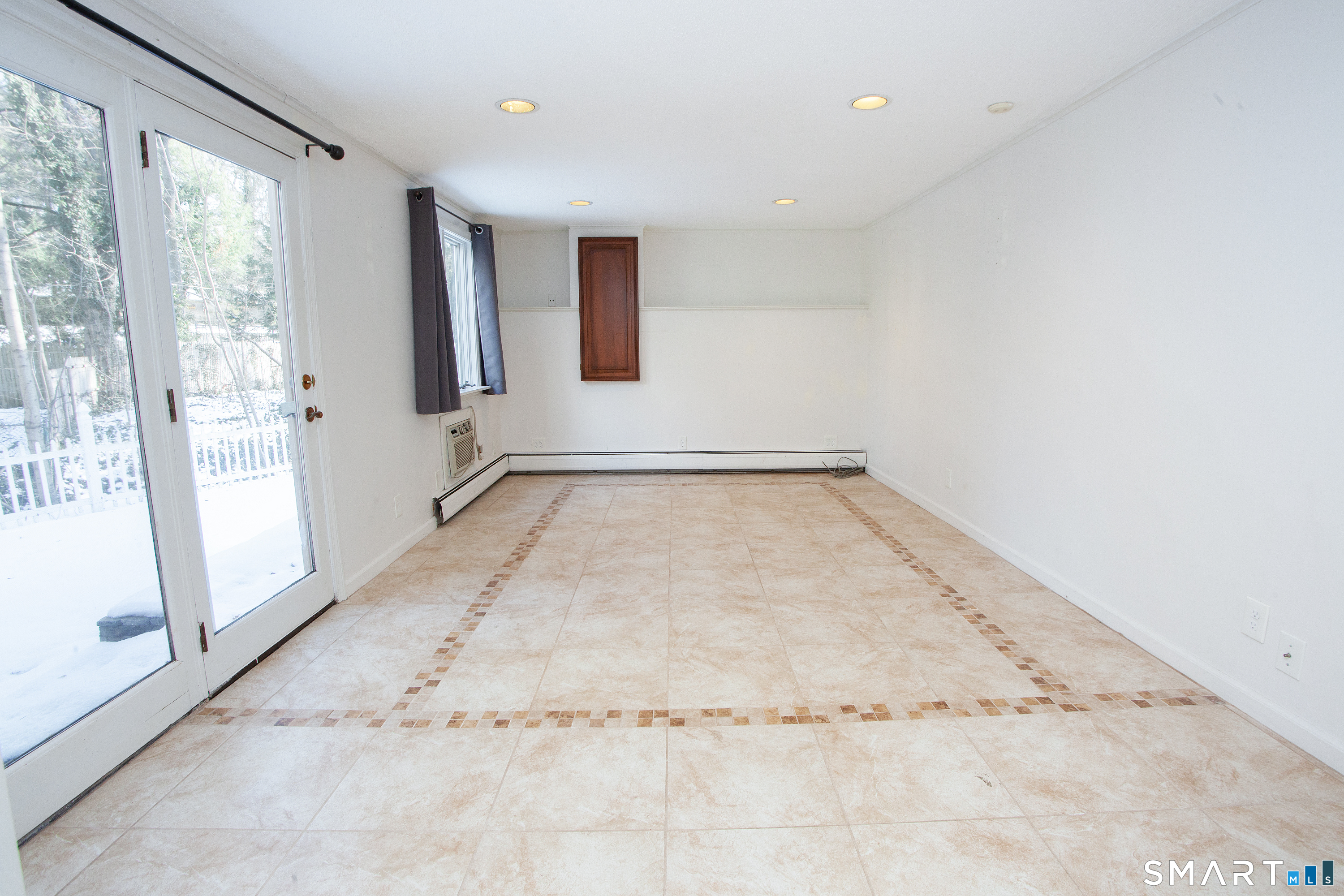 60 Ridgebrook Drive West Hartford, CT 06107 - Photo 29 of 40 This room on lower level has an attached full bath so could be a primary bedroom, a guest room, or a recreation room. All with a patio right outside the door!