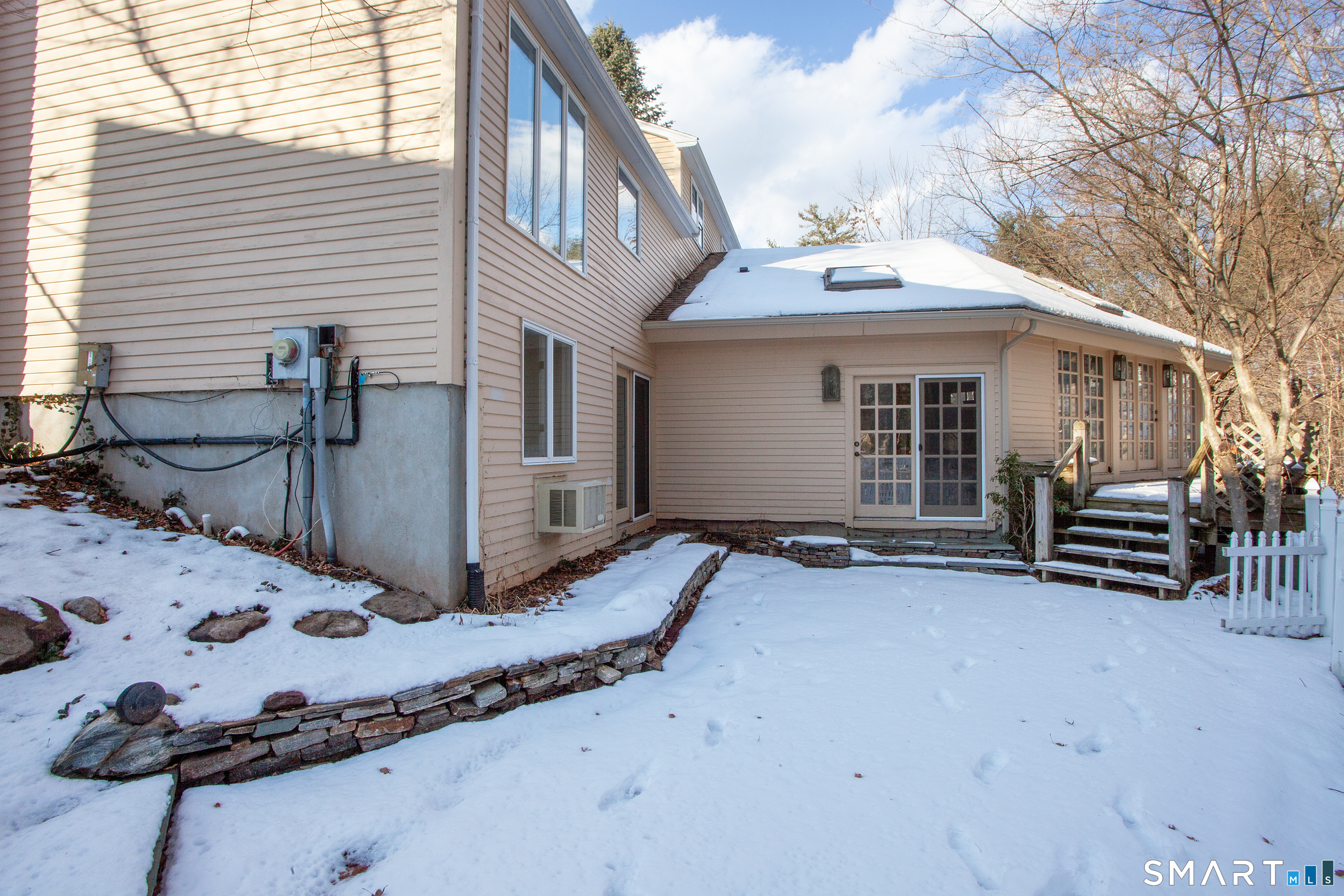 60 Ridgebrook Drive West Hartford, CT 06107 - Photo 34 of 40 there is a brick patio beneath the snow