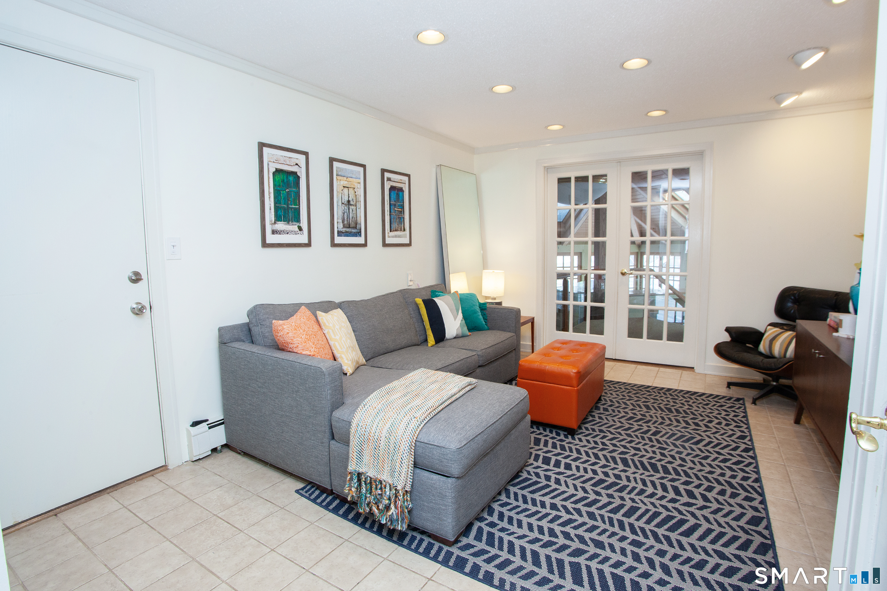 60 Ridgebrook Drive West Hartford, CT 06107 - Photo 5 of 40 first floor family room with french doors leading to sunroom and garage door to the left
