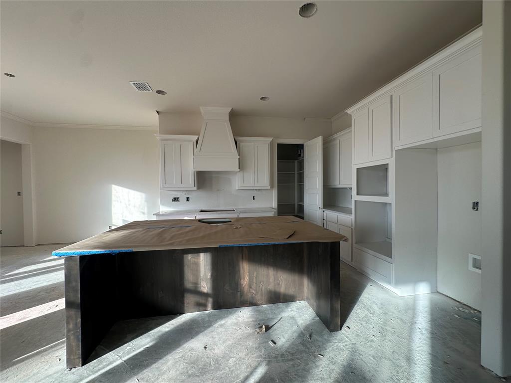 201 Stuart Street Paradise, TX 76073 - Photo 12 of 18 a kitchen with stainless steel appliances a sink stove and cabinets