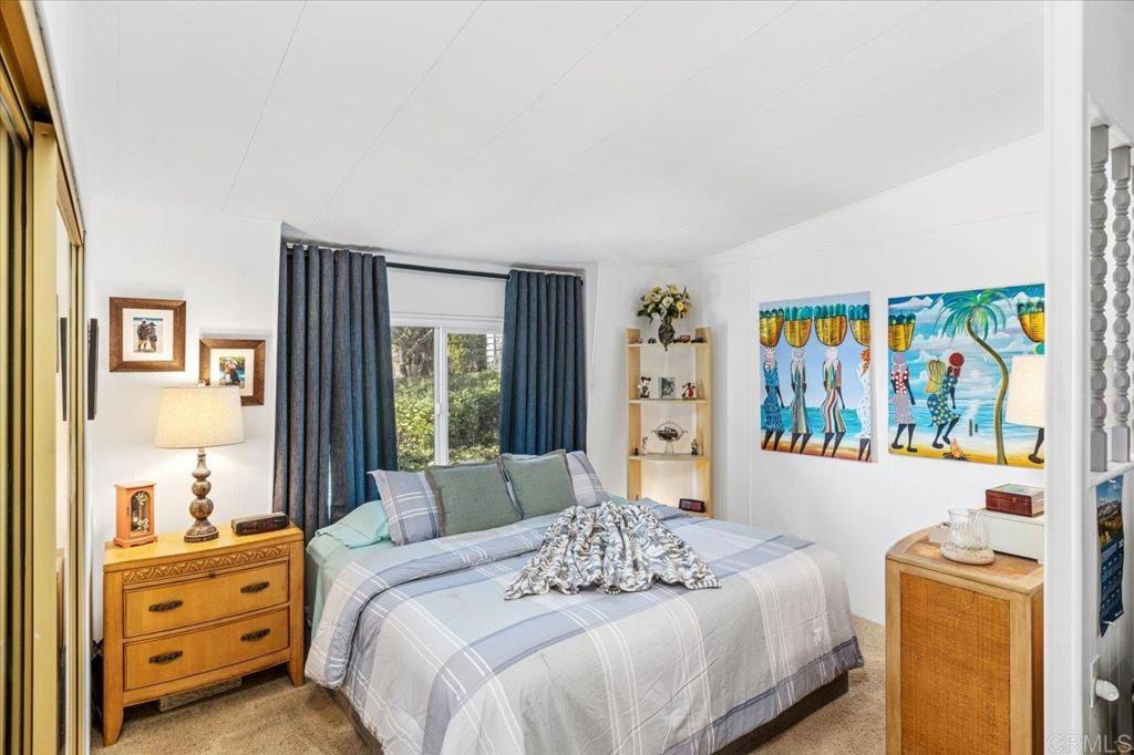 18218 Paradise Mountain Road, Unit 116 Valley Center, CA 92082 - Photo 6 of 35 a bedroom with a bed and a window