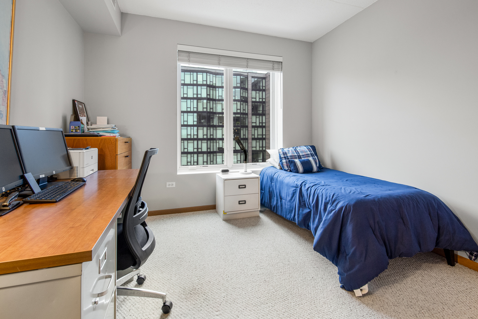 515 Main Street, Unit 505 Evanston, IL 60202 - Photo 11 of 15 a bedroom with a bed and a desk