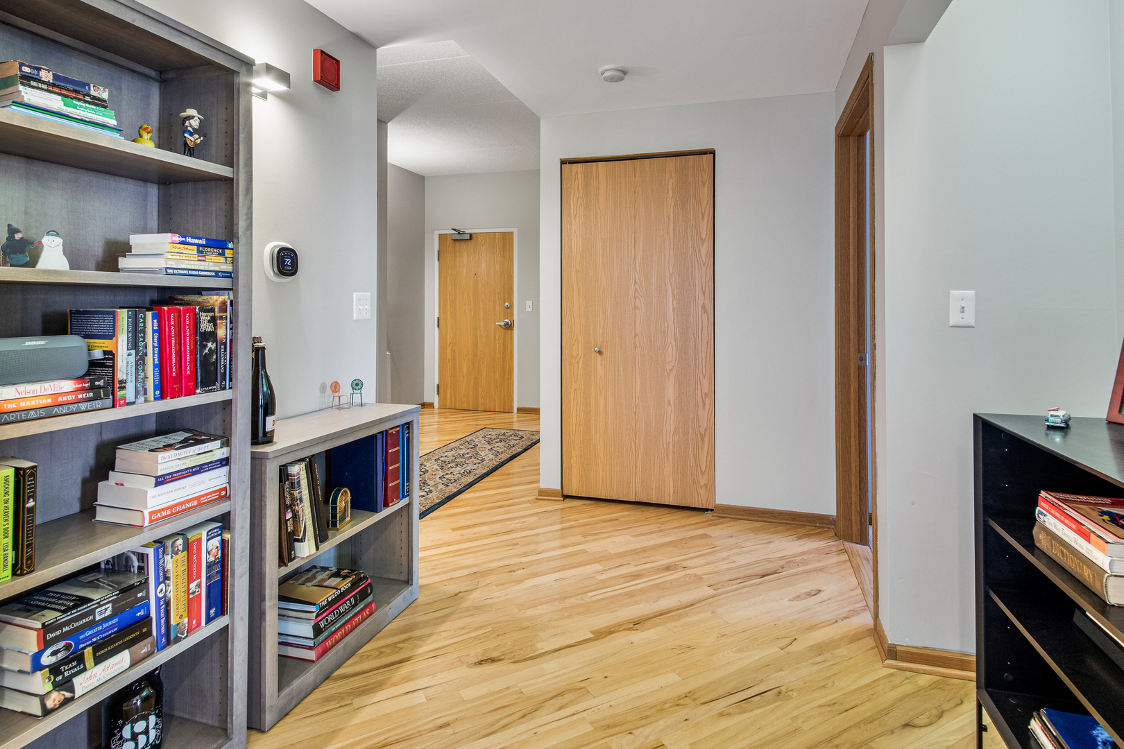 515 Main Street, Unit 505 Evanston, IL 60202 - Photo 2 of 15 a view of an empty room with shelves and wooden floor
