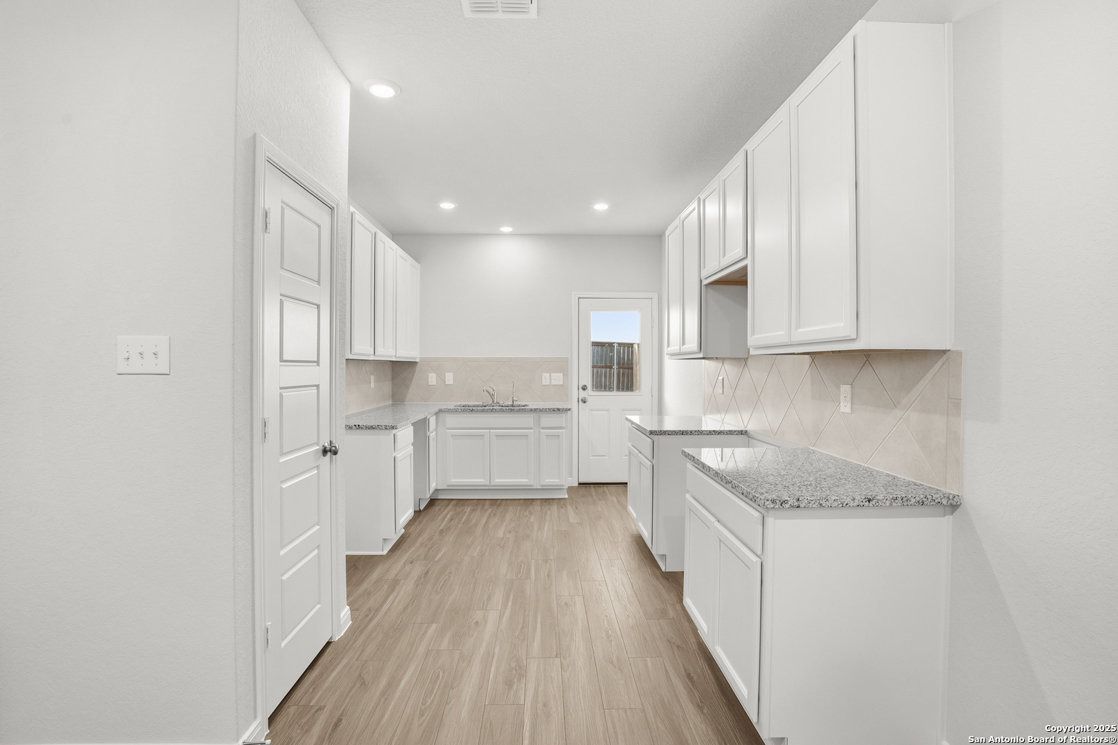 3211 Katzer Lane Converse, TX 78109 - Photo 8 of 28 a kitchen with white cabinets appliances and sink