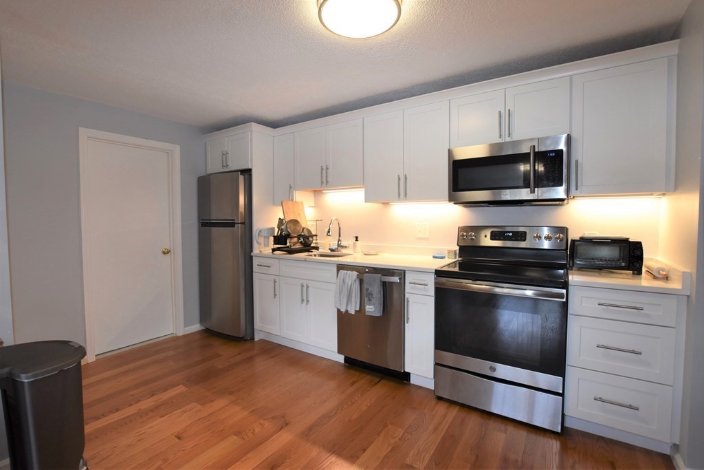 a kitchen with a refrigerator stove and microwave
