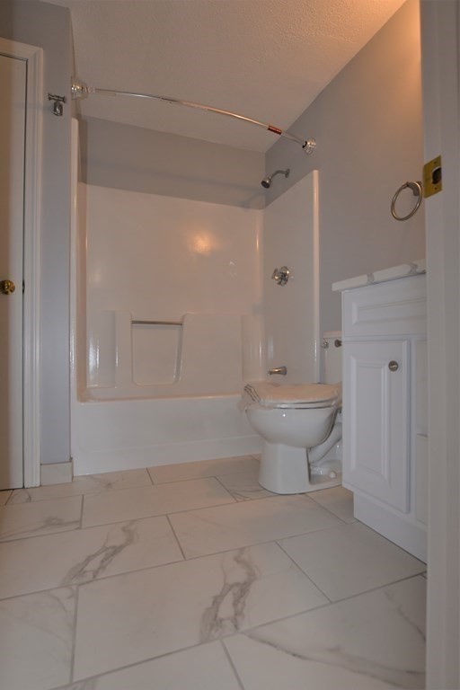 88 Charles Street, Unit 1 Waltham, MA 02453 - Photo 11 of 14 a bathroom with a toilet and a shower
