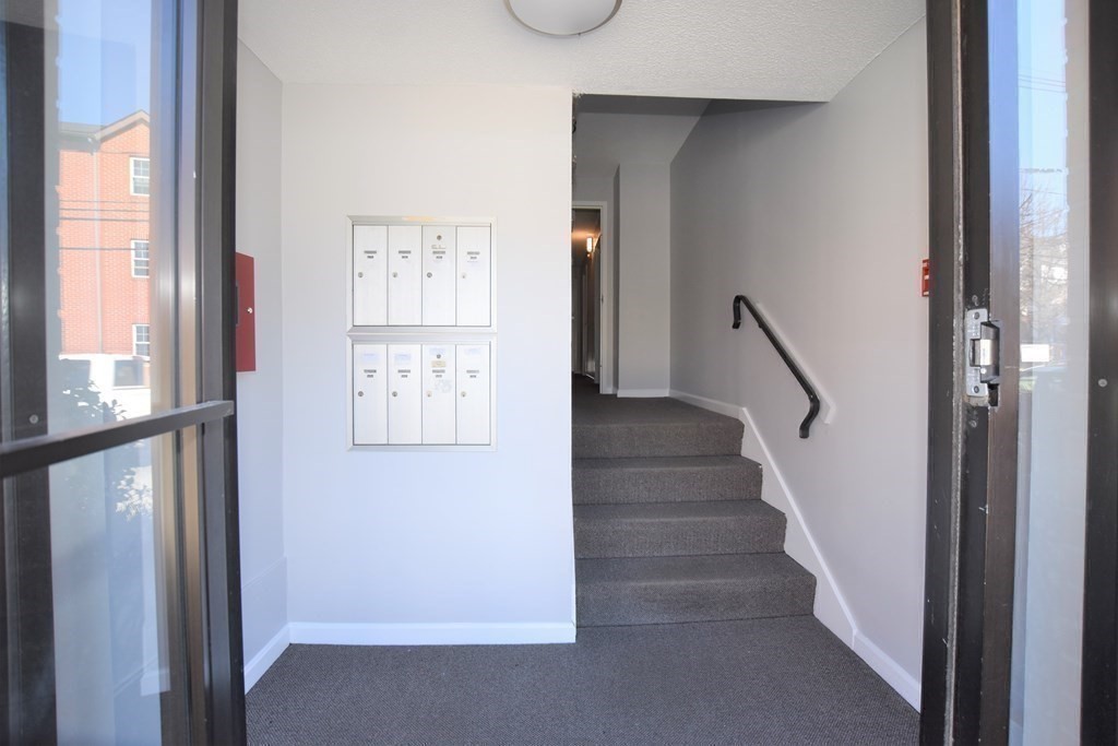 88 Charles Street, Unit 1 Waltham, MA 02453 - Photo 13 of 14 a view of entryway with wooden floor and stair