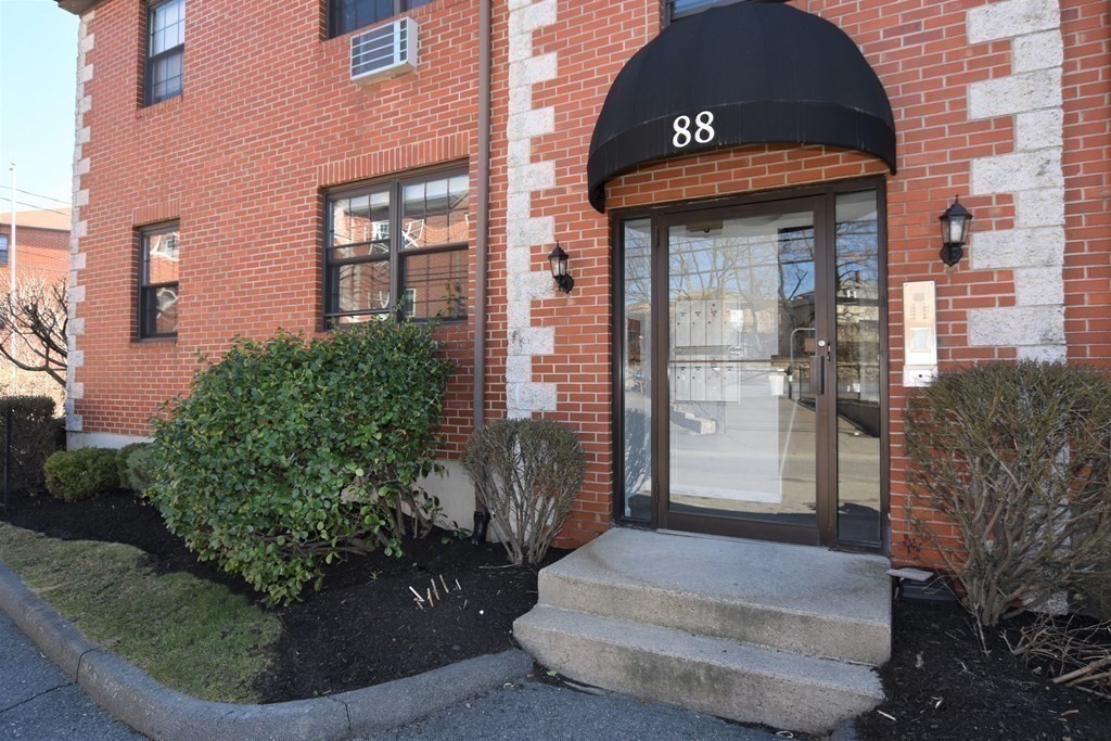 88 Charles Street, Unit 1 Waltham, MA 02453 - Photo 14 of 14 a front view of a house with a yard