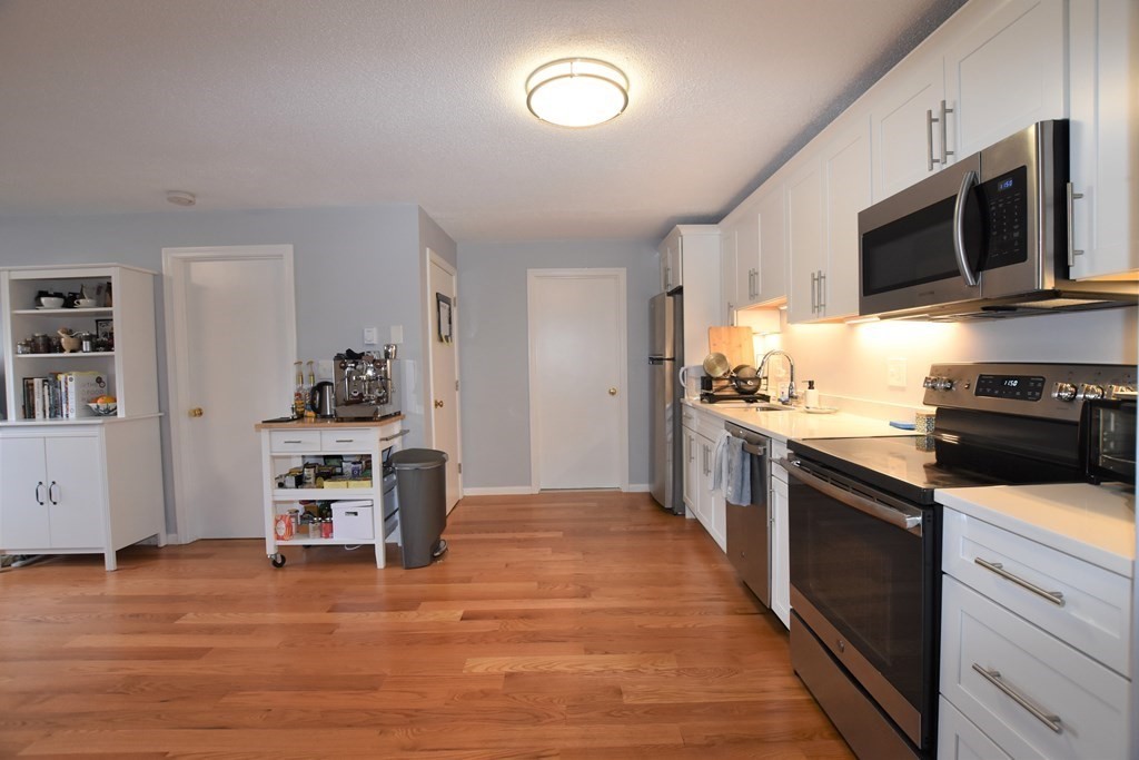 88 Charles Street, Unit 1 Waltham, MA 02453 - Photo 2 of 14 a kitchen with a sink and steel appliances