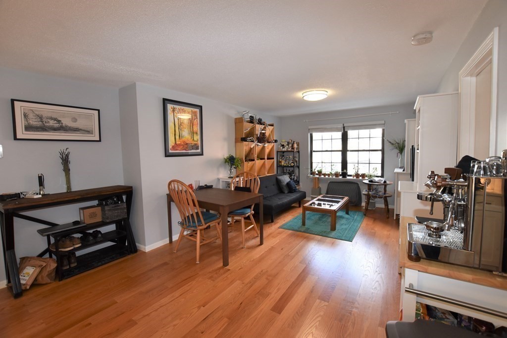 88 Charles Street, Unit 1 Waltham, MA 02453 - Photo 4 of 14 a living room with furniture and wooden floor