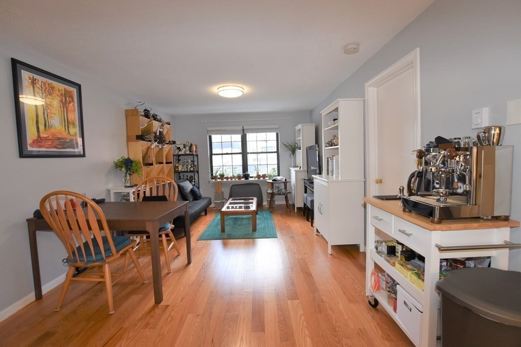 88 Charles Street, Unit 1 Waltham, MA 02453 - Photo 5 of 14 a dining room with furniture and wooden floor
