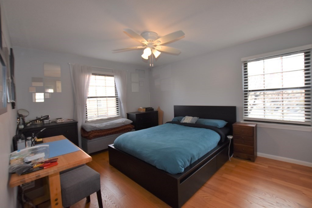 88 Charles Street, Unit 1 Waltham, MA 02453 - Photo 7 of 14 a bedroom with a bed and windows