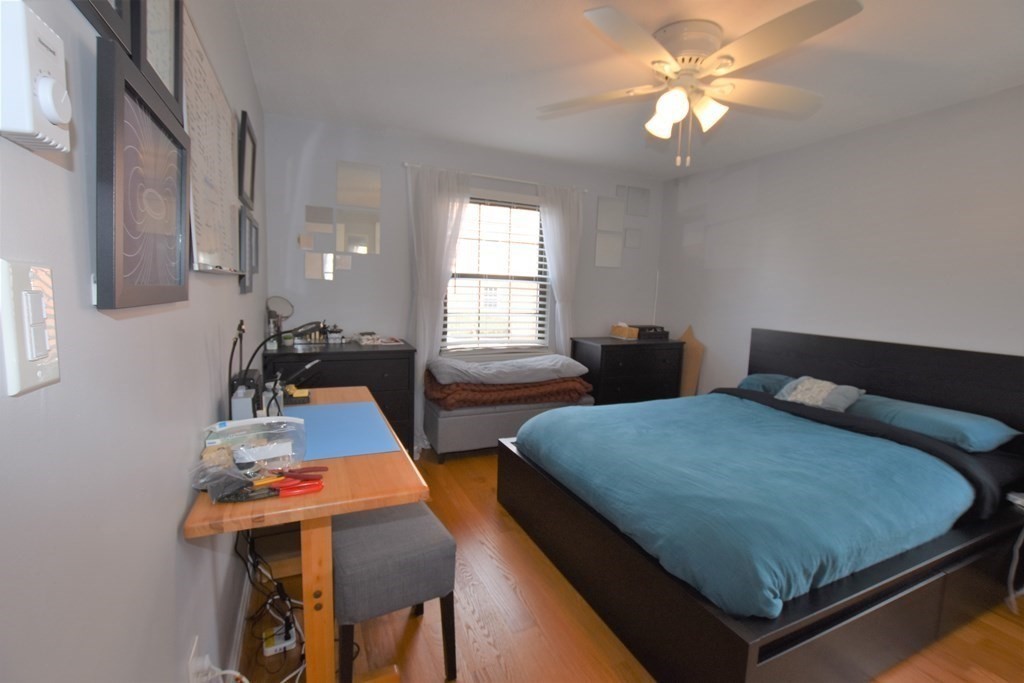 88 Charles Street, Unit 1 Waltham, MA 02453 - Photo 9 of 14 a bedroom with two beds and windows