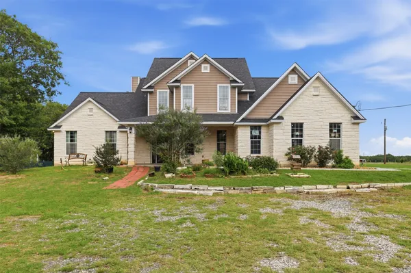 a front view of a house with a yard and porch