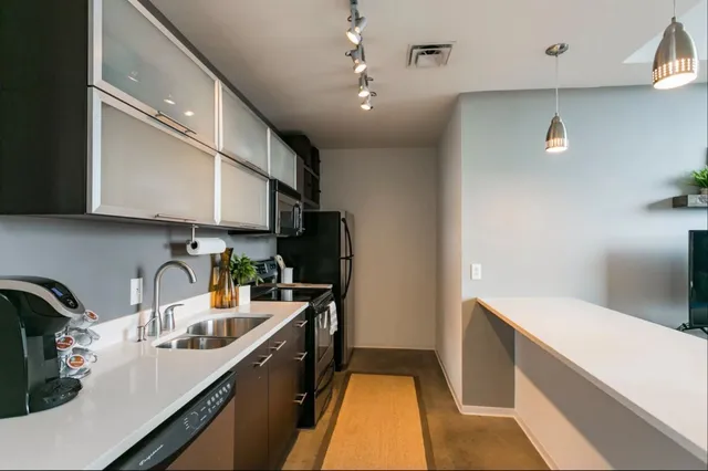 a kitchen with a sink a stove and cabinets