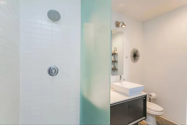 a bathroom with a sink toilet and shower