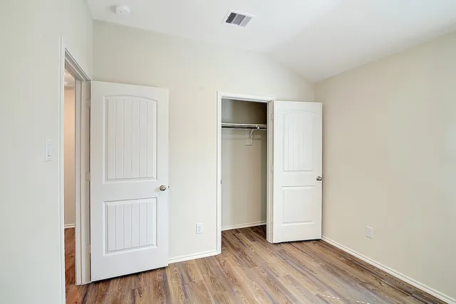a view of an empty room and wooden floor