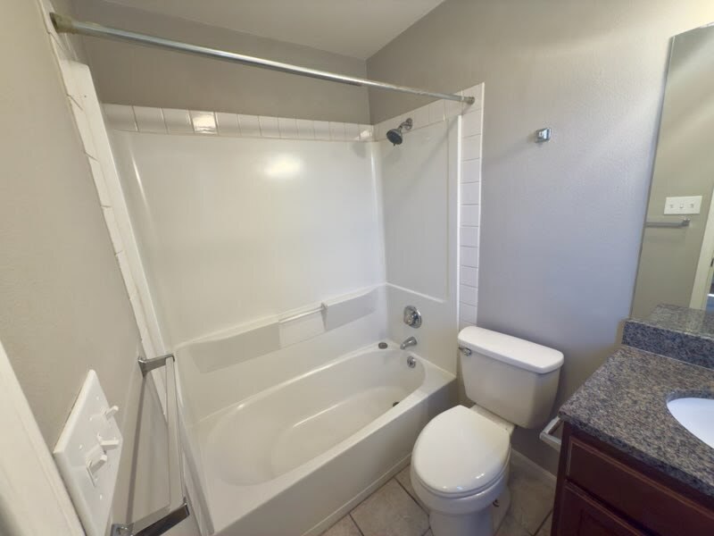 2012 Margalene Way, Unit B Austin, TX 78728 - Photo 11 of 14 a white toilet sitting next to a bath tub
