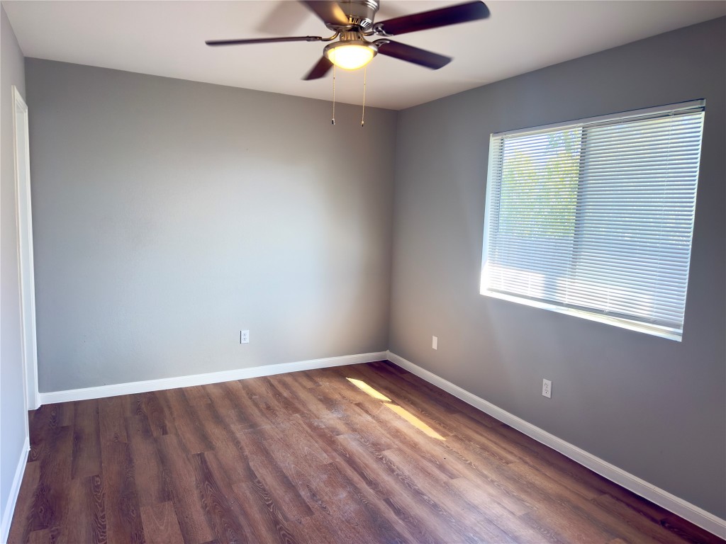 2012 Margalene Way, Unit B Austin, TX 78728 - Photo 6 of 14 an empty room with a window and wooden floor