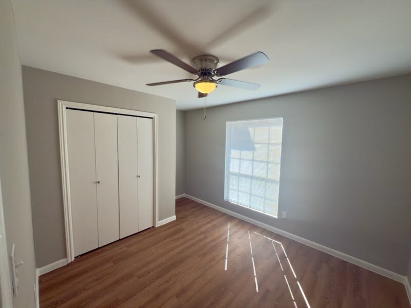 2012 Margalene Way, Unit B Austin, TX 78728 - Photo 9 of 14 wooden floor in an empty room with a window